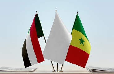 Flags of Sudan and Senegal with a white flag in the middle