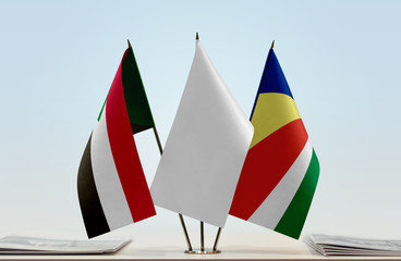 Flags of Sudan and Seychelles with a white flag in the middle