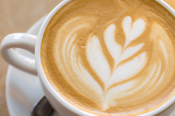 Close up Hot Coffee latte art cappuccino White cup on Wooden table