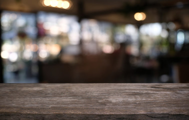 Empty wooden table in front of abstract blurred background of coffee shop . can be used for display or montage your products.Mock up for display