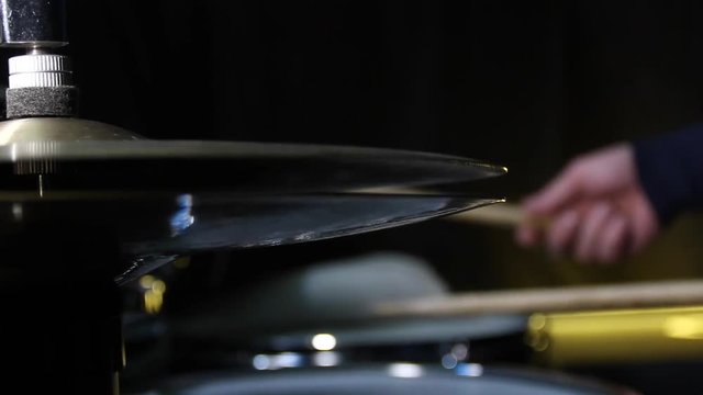 Close up of drum plate hi hat and a drummer playing on drums. Slider shot.