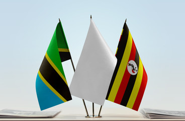 Flags of Tanzania and Uganda with a white flag in the middle