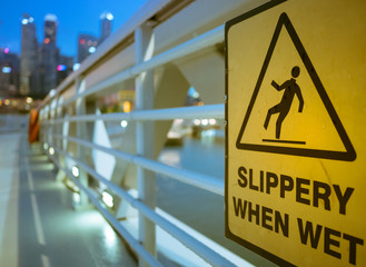 man slip on wet floor icon, yellow signage for people to walk carefully on wet floor at bridge area after rain