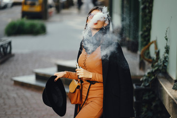 stylish girl smoking an e-cigarette