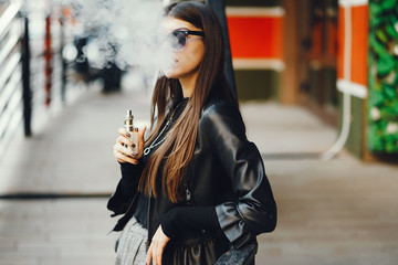 stylish girl smoking an e-cigarette