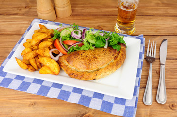 Pasty and potato wedges meal with fresh salad isolated on a white background