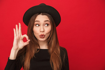Smiling young woman showing okay gesture.