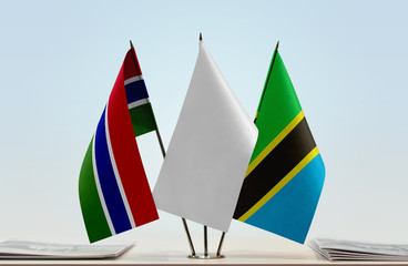 Flags of The Gambia and Tanzania with a white flag in the middle