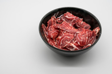 Fresh sliced beef hind shank in black ceramic bowl