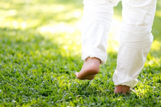 The practice of walk back and forth  in the grass of men in white pants, Meditation, peaceful and refreshing