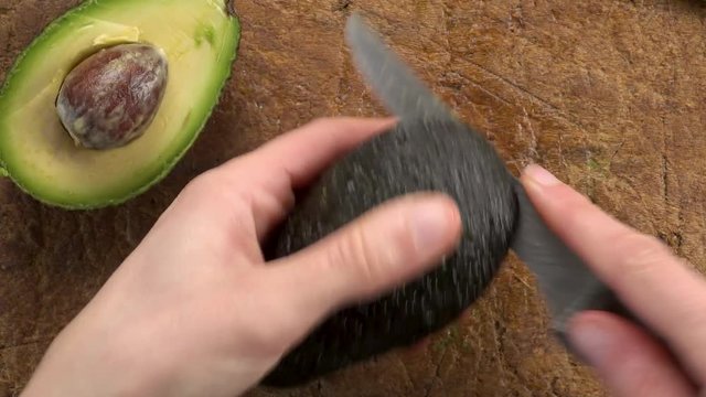 woman cutting avocado