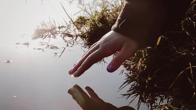 finger touching surface of water - panta rhei