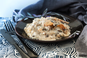 Tasty risotto with chicken, fresh herbs vegetables on a white plate