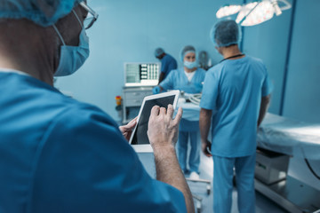 doctor using tablet in surgery room