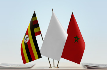 Flags of Uganda and Morocco with a white flag in the middle