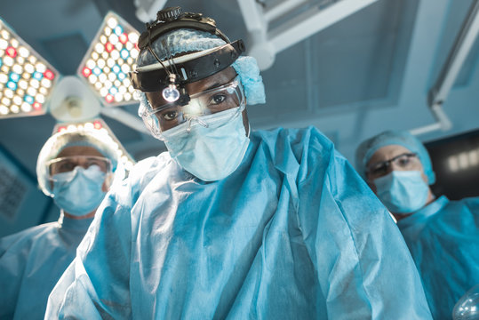bottom view of african american surgeon looking at camera