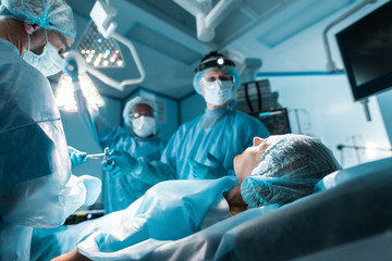 patient lying on operating table in surgery room