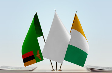 Flags of Zambia and Ivory Coast with a white flag in the middle