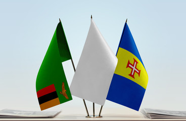 Flags of Zambia and Madeira with a white flag in the middle