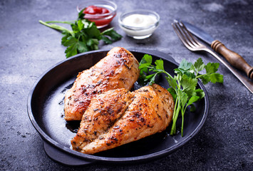Grilled chicken breast or fillet on iron pan - obrazy, fototapety, plakaty