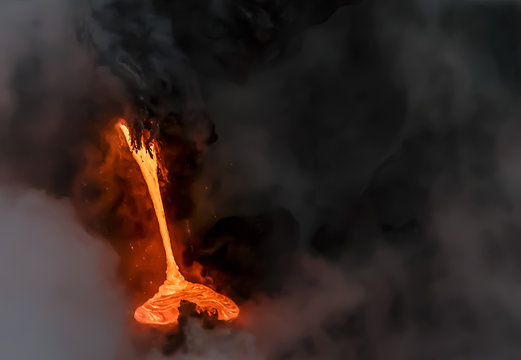 Lava pouring into the Pacific Ocean on the south coast of Hawaii's Big Island.  Photo taken from a boat at sunrise.