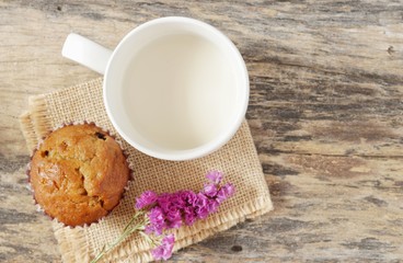 Top view, Soy milk cup with banana cupcake on sack on the old wooden table