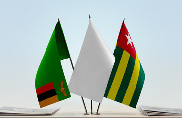 Flags of Zambia and Togo with a white flag in the middle