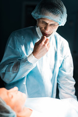 doctor looking at patient in surgery room