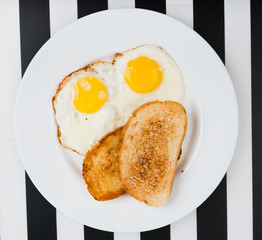 Traditional breakfast with fried eggs and toast