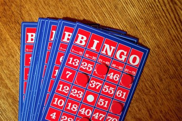 The vintage bingo card on wooden table