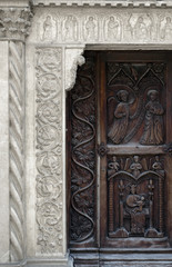 Carved medieval church portal in Grazzano Visconti, Italy