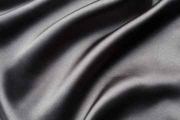 Abstract, elegant background texture with waves of silk, satin luxury cloth fabric