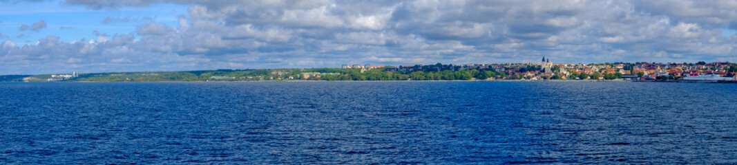Fototapeta premium Panoramic view of coastal landscape with city