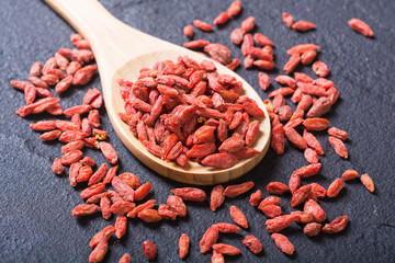 Goji berries in wooden spoon