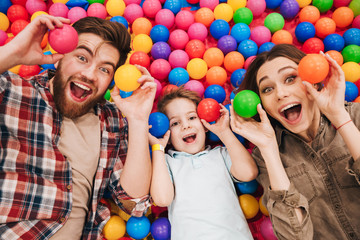 Fototapeta na wymiar Emotional little child have fun with his parents.