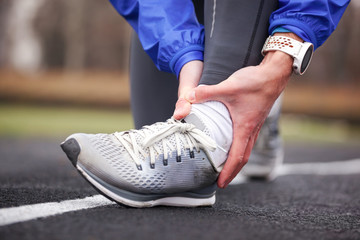 Cropped shot of a young man holding his ankle in pain sprain a foot.