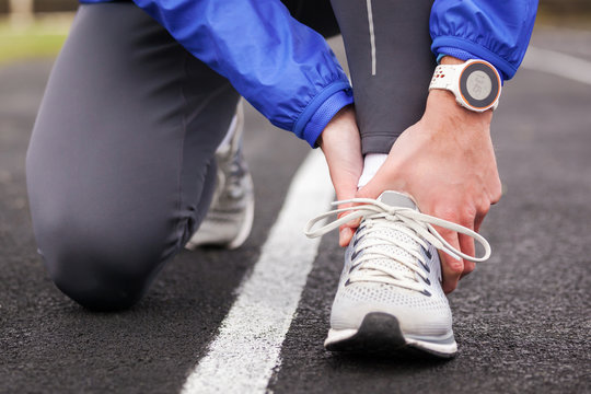 Cropped Shot Of A Young Man Holding His Ankle In Pain Sprain A Foot.