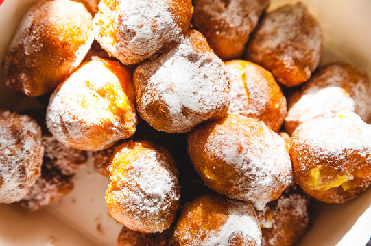 closeup of italian frittelle baked carnival sweets with cream with natural light