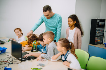 group of kids listening to teacher at machinery class