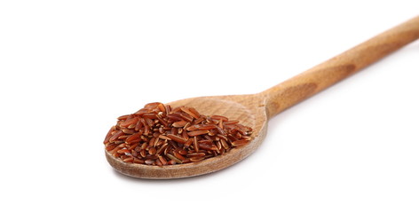 Red wild rice pile in wooden spoon isolated on white background