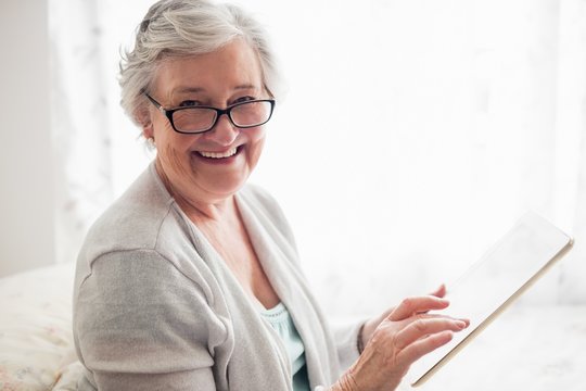 Senior woman smiling - Powered by Adobe