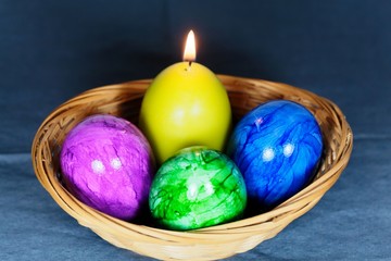 Colored Easter eggs with a candle