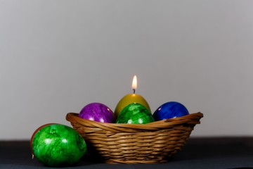 Colored Easter eggs with a candle