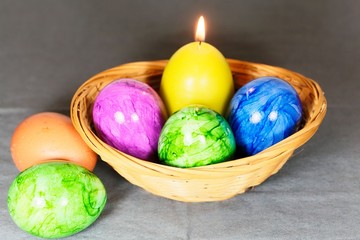 Obraz na płótnie Canvas Colored Easter eggs with a candle
