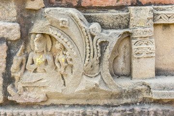 votiv stupa with statue of Buddha golden foils in Sarnath, Varanasi, Uttar Pradesh, India