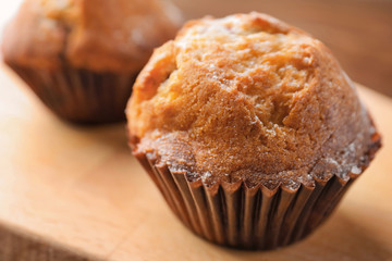 Freshly baked cupcake on wooden board, closeup