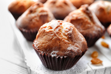 Freshly baked cupcakes on wooden board