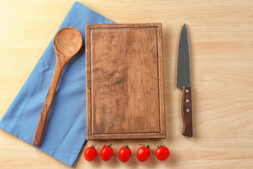 Kitchen utensils and tomatoes on wooden background. Cooking master classes