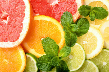 Citrus slices decorated with mint as background pattern