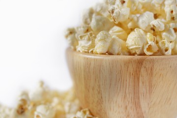 Butter popcorn in the wooden bowl on white background,Close up